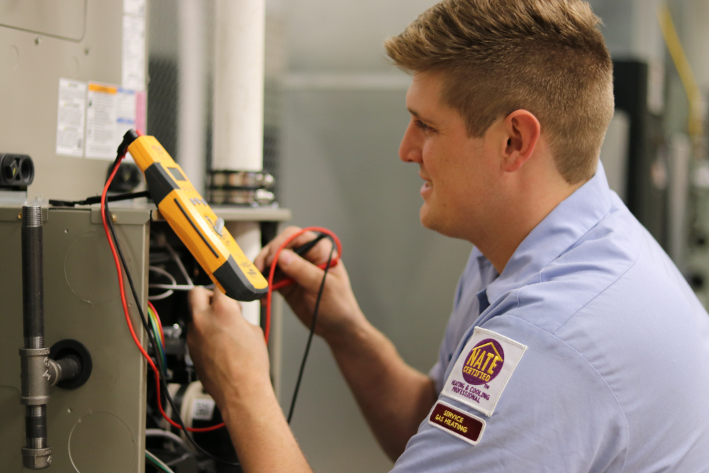 Technician Diagnosing Malfunctioning Equipment