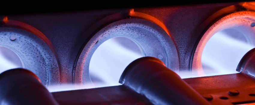 A gas furnace's burners ignite.