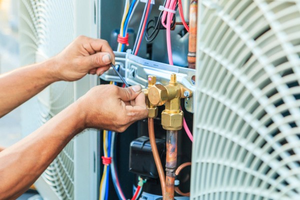 A technician working on a heat pump.
