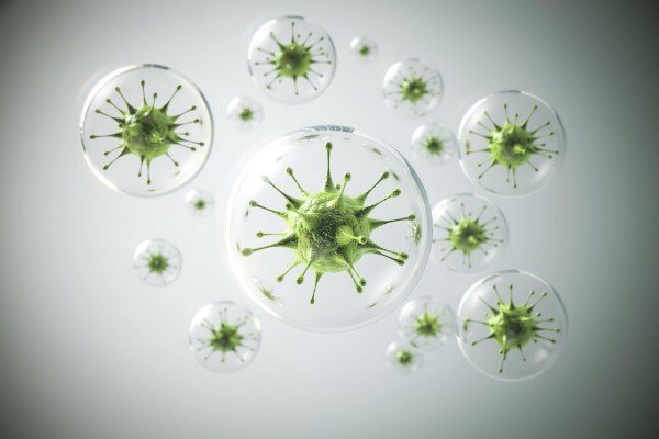 A group of green germs sitting inside of a bubble