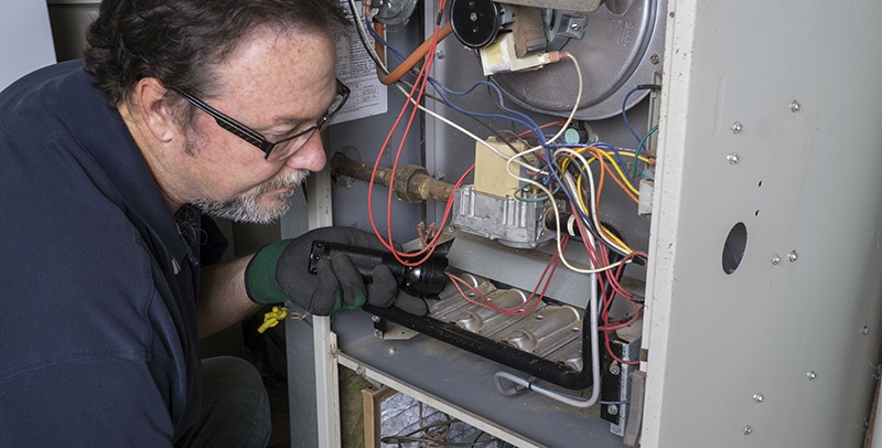 A technician working on a furnace