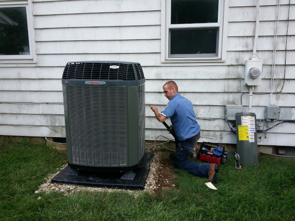 HVAC Technician installing a heat pump